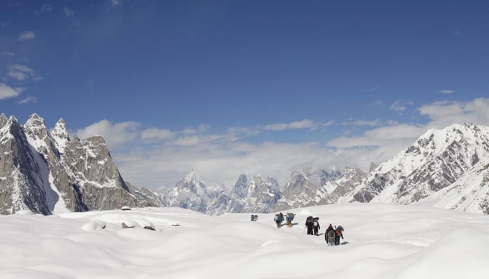 Trekkers And Porters Hike Down The Baltoro Glacier In The Karakoram Mountain Range In Pakistan September 7, 2014. — Reuters