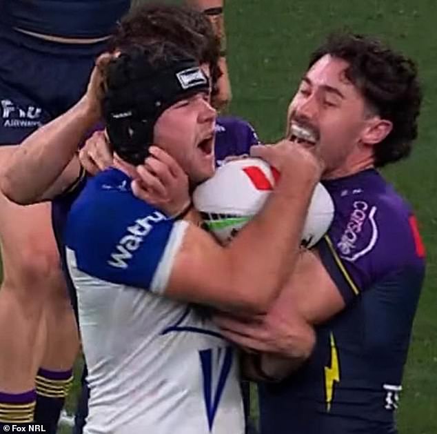 Footy Fans Were In Disbelief On Friday Night Following A Bizarre Incident Where Melbourne Storm Star Grant Anderson Was Penalised For An On-Field 'Head Rub' (Pictured Left)