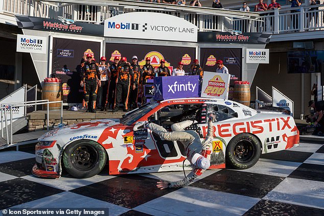 As He Attempted To Hoist Himself Onto The Roof Of The Car While Holding A Drink Sponsor's Can, Zilisch Slipped With His Foot Stuck Inside His Driver's Side Window, Preventing A Clean Escape