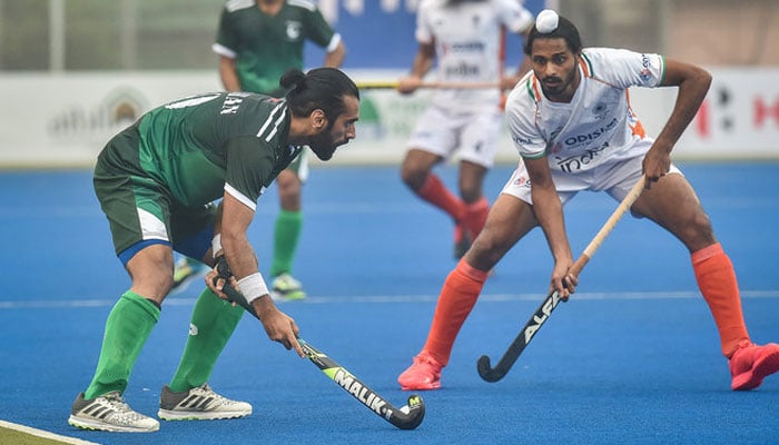 Pakistans Ali Shan, Left, And Indias Gursahibjit Singh Fight For The Ball During The Mens Field Hockey Match Between India And Pakistan At The Asian Championship Trophy Tournament. — Afp/File