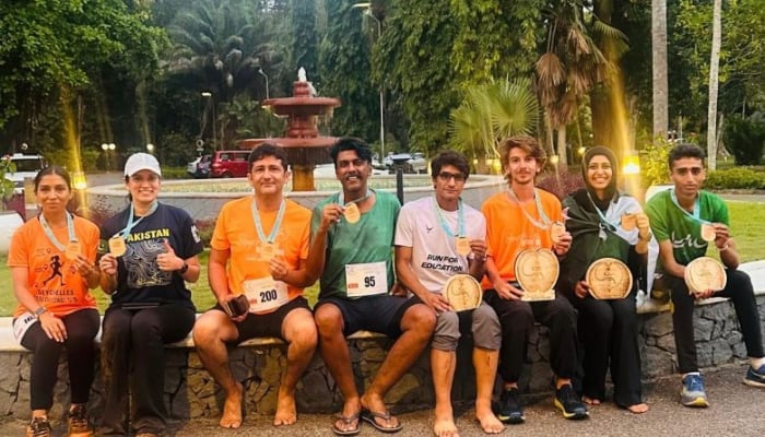 Pakistani Journalist Raja Mohsin Ejaz (Left) And Geo’s Deputy Sports Editor Faizan Lakhani (Centre), Along With Other Male And Female Participants, Pose For A Picture During The Seychelles Nature Trail Challenge 2025 At Mahé Island, Seychelles, On August 24, 2025. — Reporter