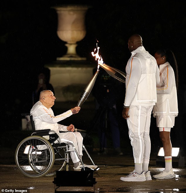 Coste Passes The Torch To French Athlete Marie-Jose Perec And French Judo Practitioner Teddy Riner Walk To Light The Olympic Cauldron At The Gardens Of The Tuileries At The 2024 Games