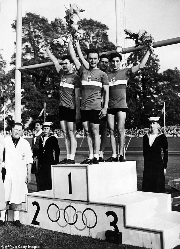 Gold Medalists French Fernand Decanali, Pierre Adam, Serge Blusson And Charles Coste Pose On The Podium After The Men's Team Pursuit Finals Track Cycling Event At The 1948 Games