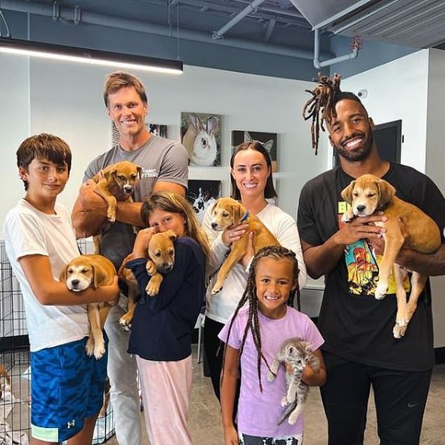 Brady And Two Of His Children Are Seen Holding Dogs At A Local Shelter In This Social Media Pic