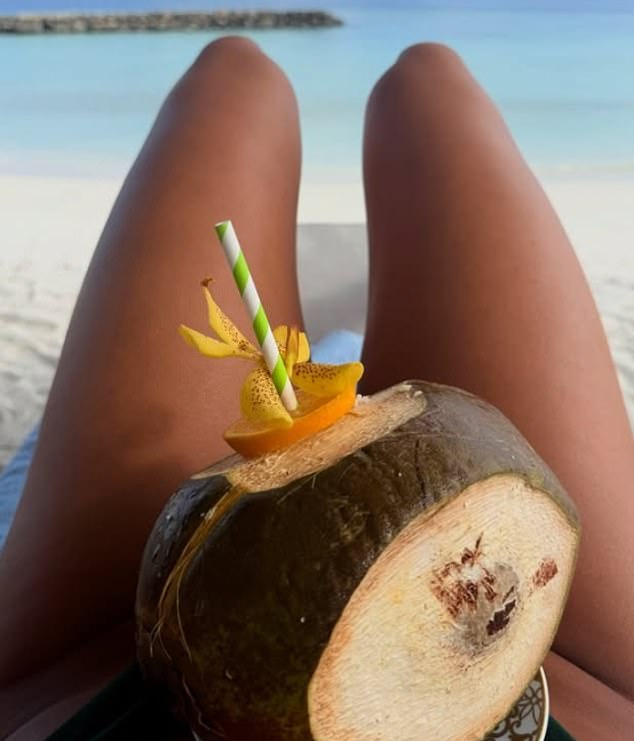 She stayed hydrated amid the scorching sun by drinking out of coconuts by the sea