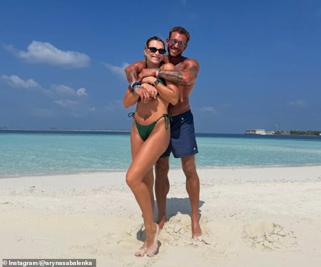 She cuddled with Brazillian entrepreneur Frangulis on the beach during her idyllic stay