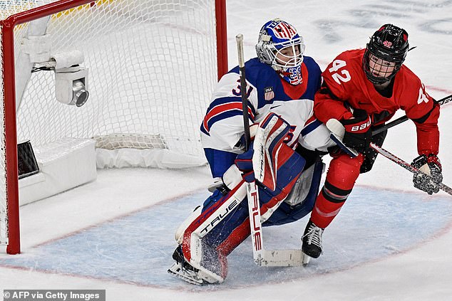 Canada's Claire Thompson Vies For The Puck With Usa's Goalkeeper Aerin Frankel