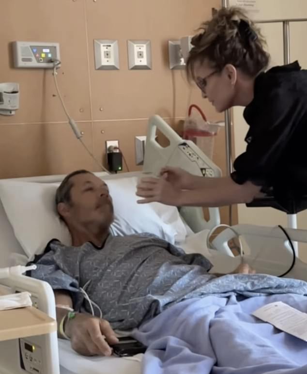Duguay In A Hospital Bed Being Tended By His Girlfriend And Former Alaska Governor Sarah Palin