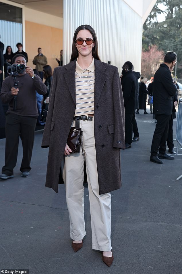 Clark Wore Beige Tailored Khakis, A Striped Polo And Grey Coat Draped Over Her Shoulders