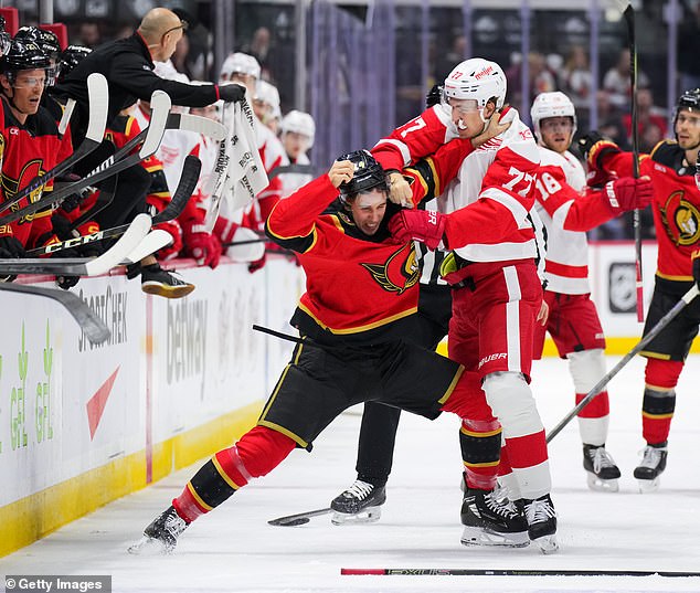 Simon Edvinsson Of The Detroit Red Wings Fights Dylan Cozens After The Hit On Tkachuk