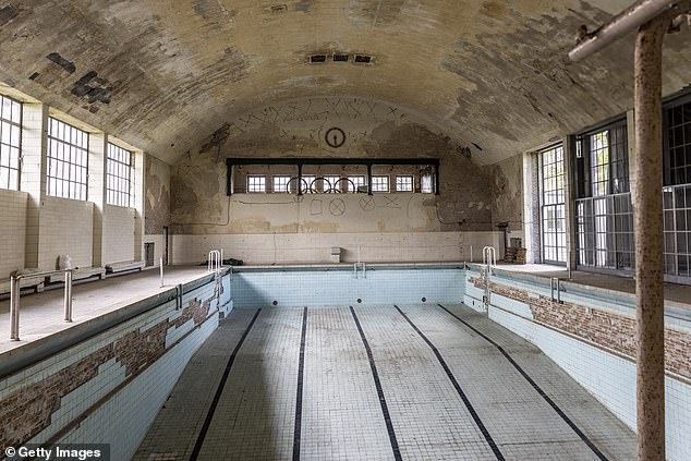 A Swimming Pool Lies Abandoned In The Former Swim Hall Of The 1936 Berlin Olympic Village