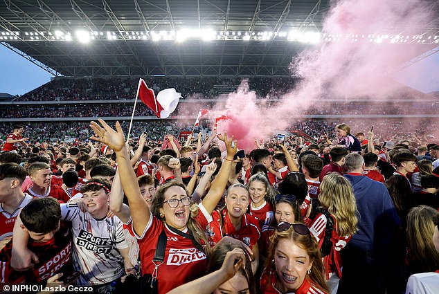 As Young Cork Fans Celebrated, One Held Up A Flare That Belched Red Smoke Into The Night.